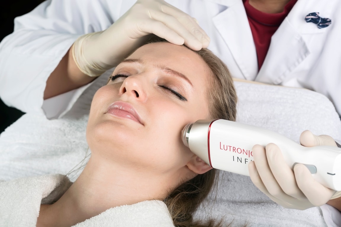 an image of a woman receiving microneedling treatment with Infini.